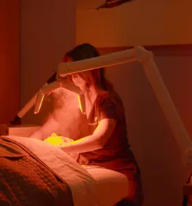 Facial Specialist peforming facial using LED Facial Treatment Device