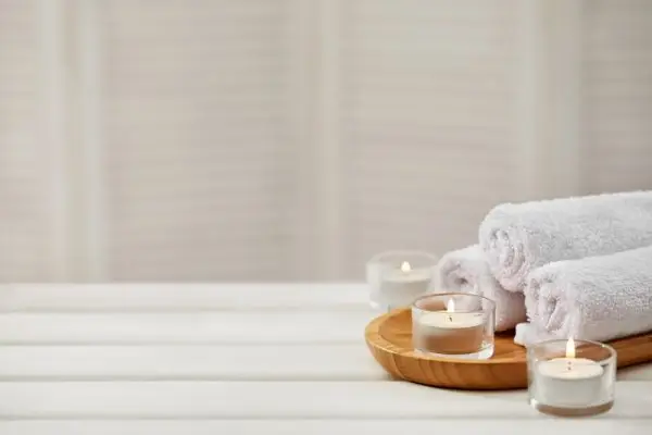 Warm towels and candles for spa ambiance
